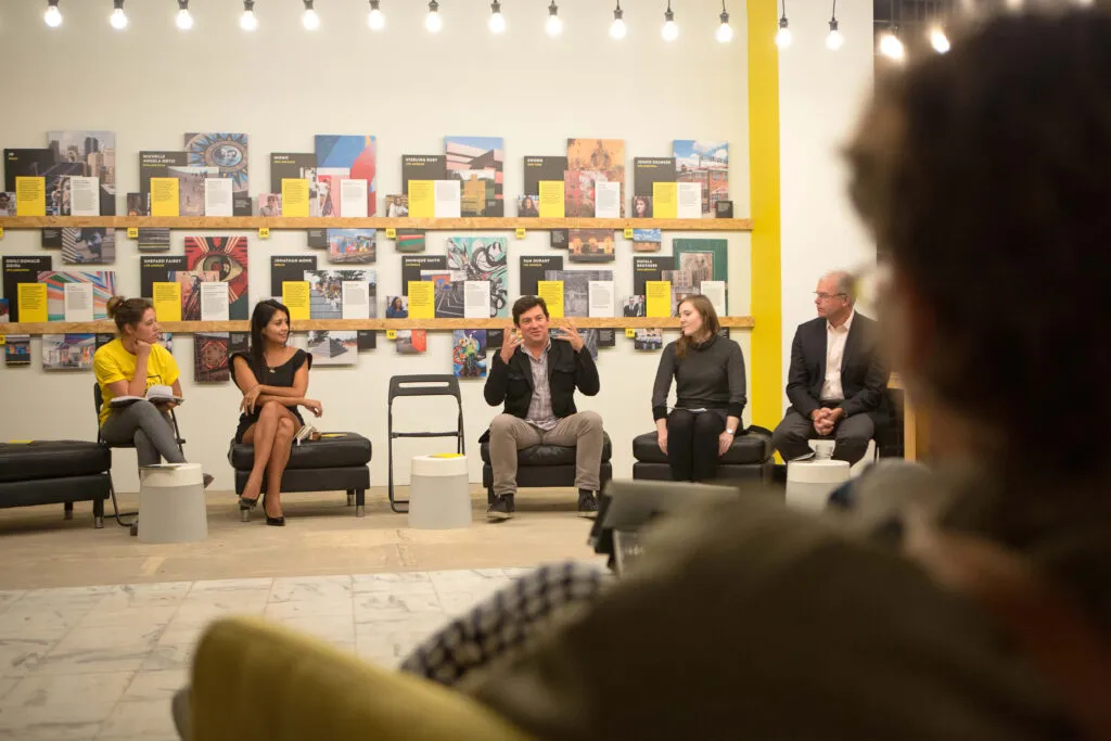 curator facilitating conversation inside exhibition for city-wide art exhibition for Mural Arts by J2