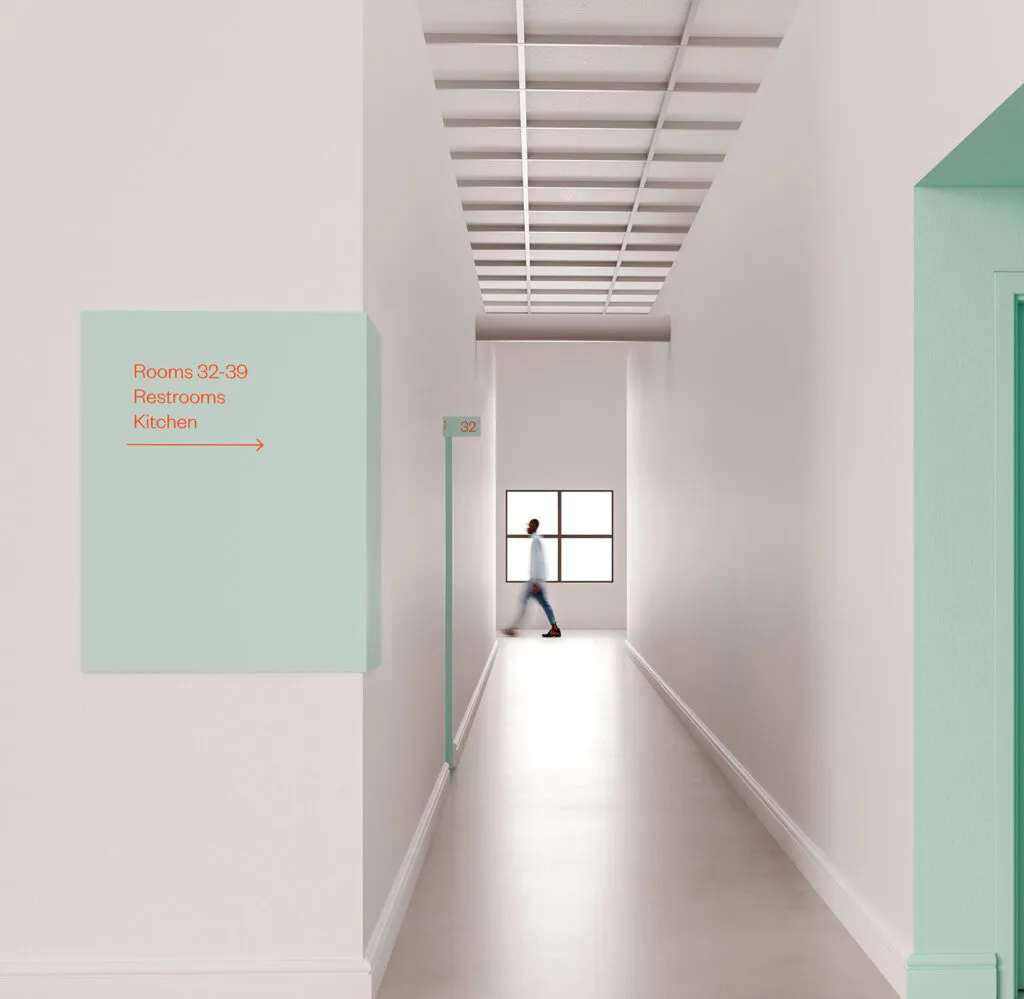 A teal wall directional in an Asian Arts hallway