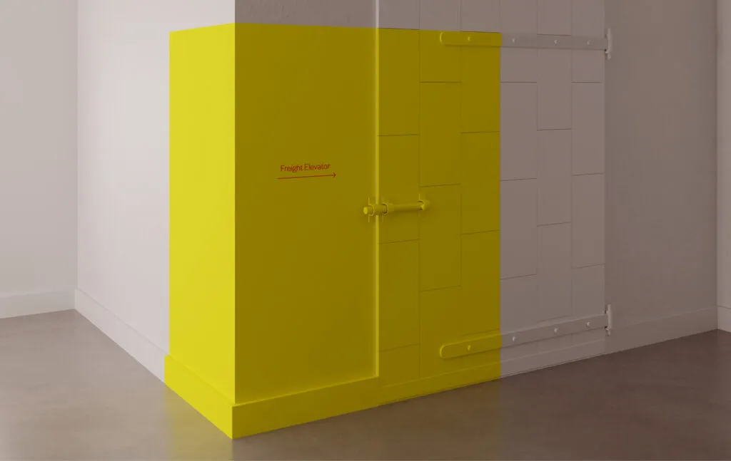 Yellow wall graphic with arrow direction towards Freight Elevator