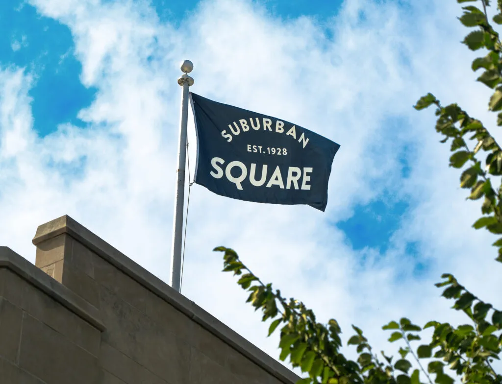 flag waving on top of building with logo type