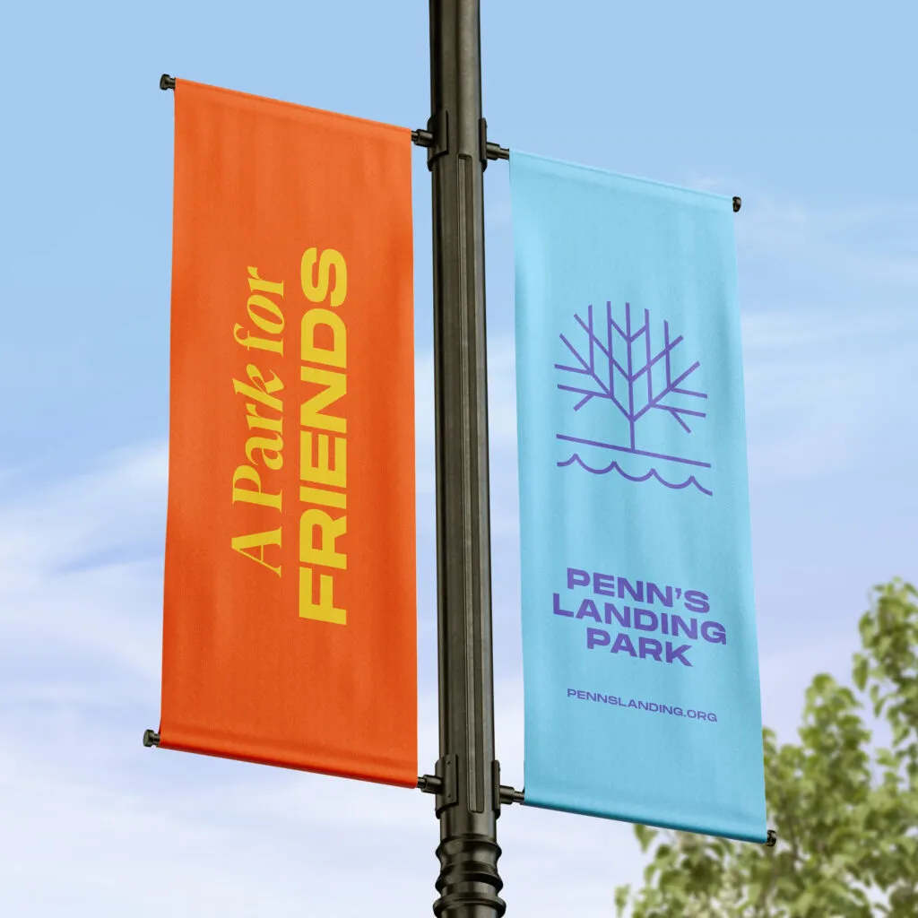 Logo and typography on bright color banners hung from lamppost. Penn's Landing Park branding project.