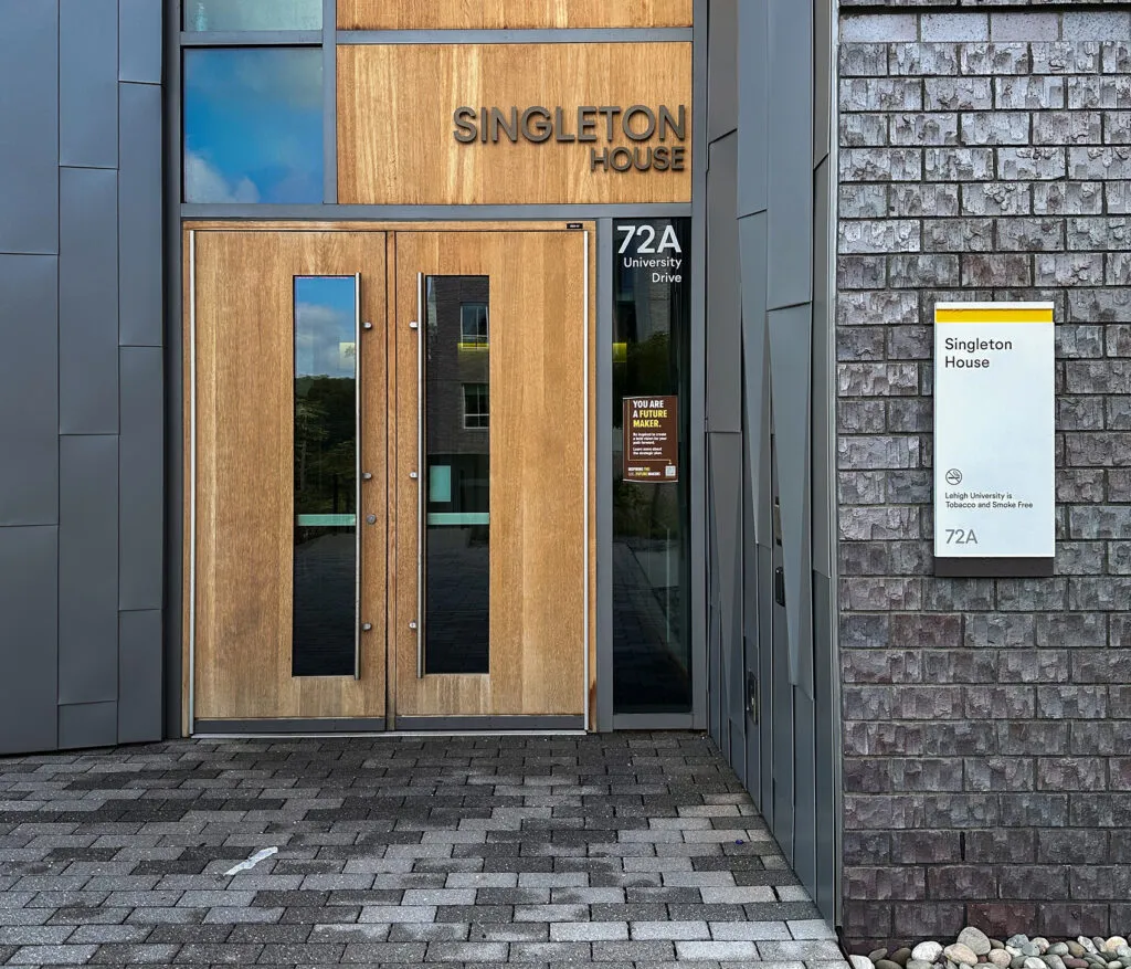 Photo of Singleton House entrance and exterior building identification sign at Lehigh University.