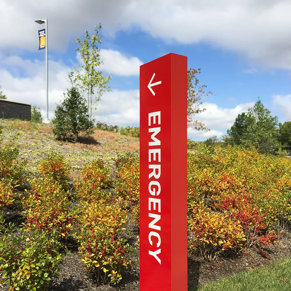 Freestanding directional sign that directs towards emergency department.