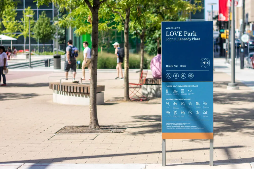 Love park sign at John F. Kennedy Plaza. Sign lists hours and park rules