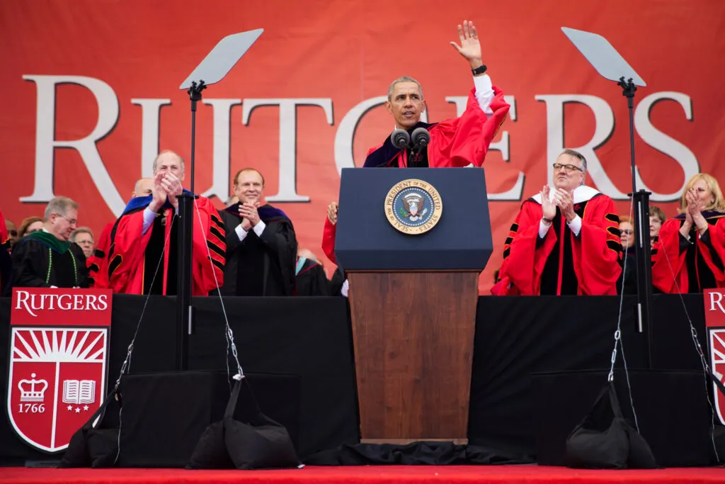 Obama standing next to Rutgers logo