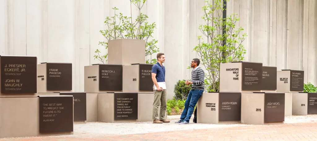 Two people sitting and chatting on blocks
