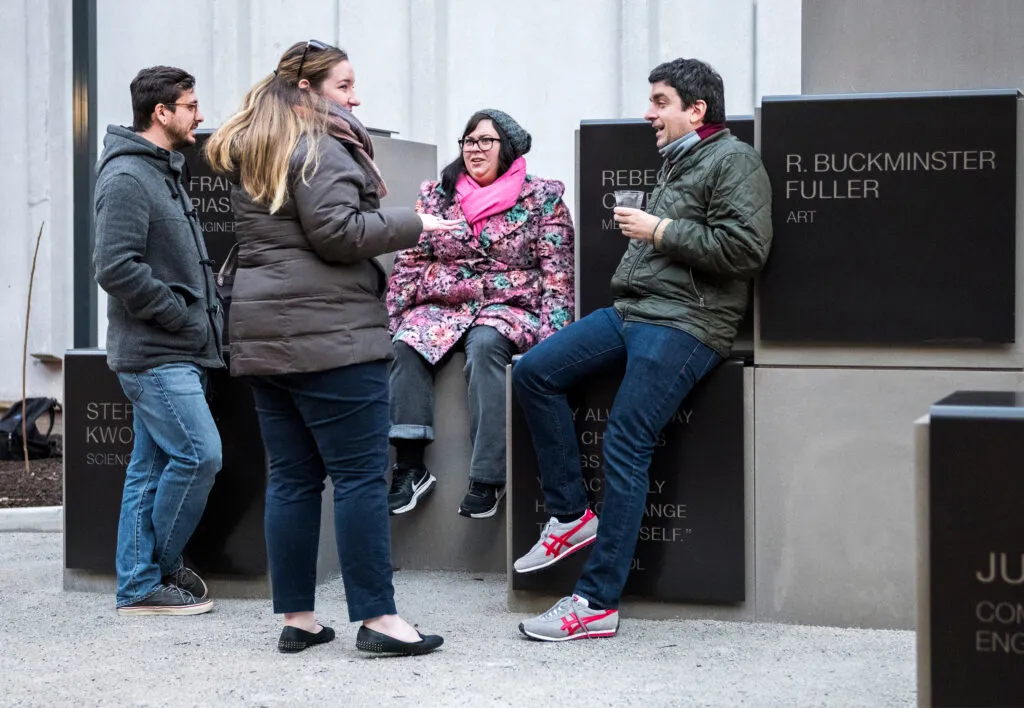 Four friends sitting and chatting on blocks