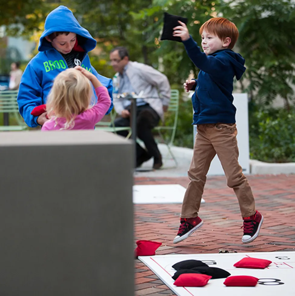 Boy playing cornhole