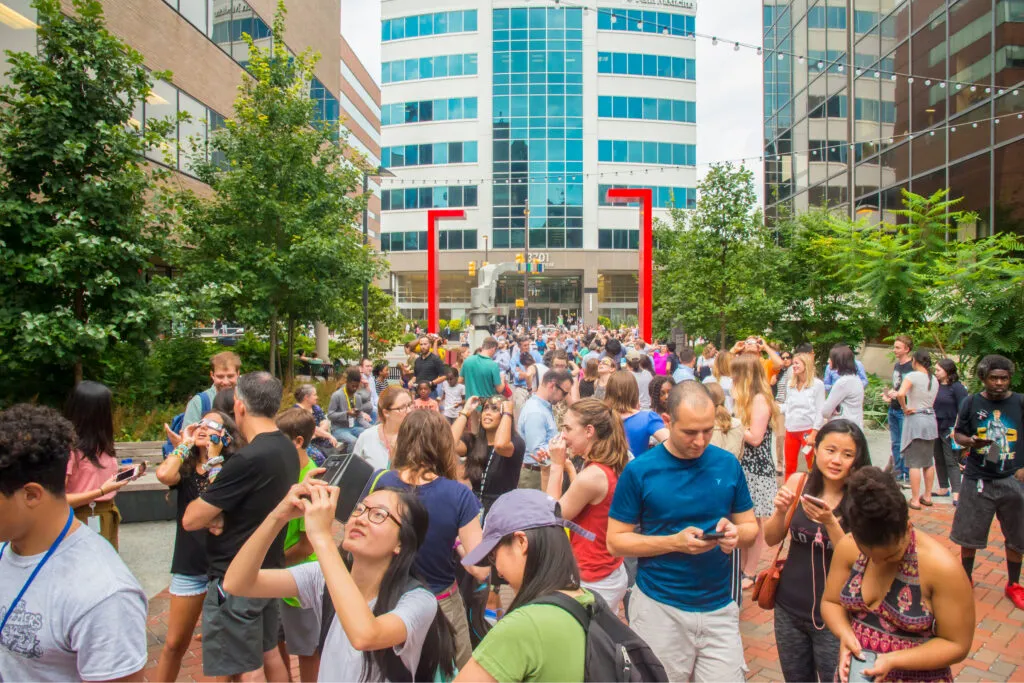 Crowd gathers to watch a solar eclipse
