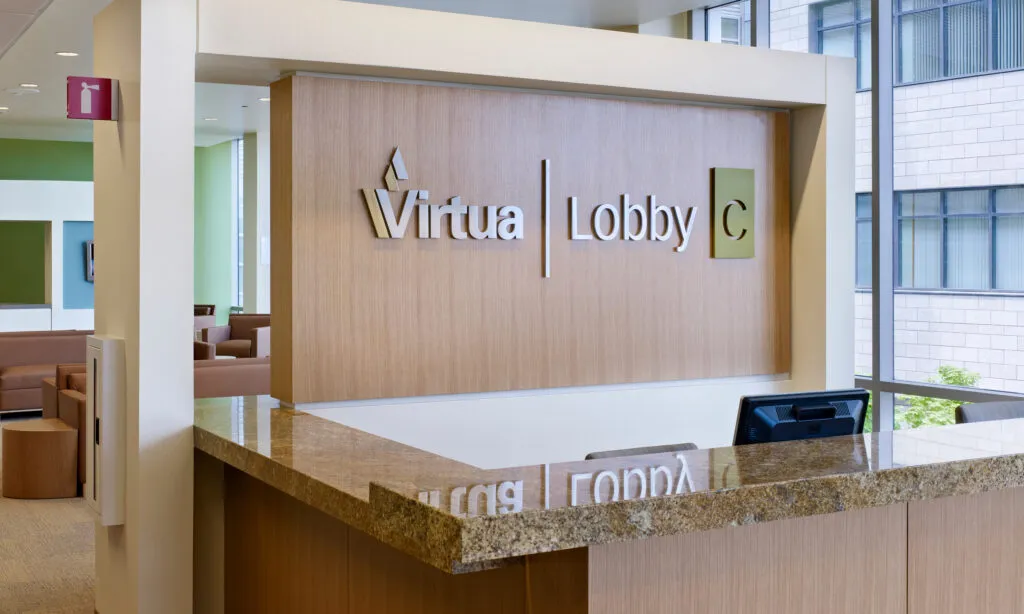 Lobby C an Virtua Voorhees Hospital. The welcome desk includes a large wall sign with lobby name and branding