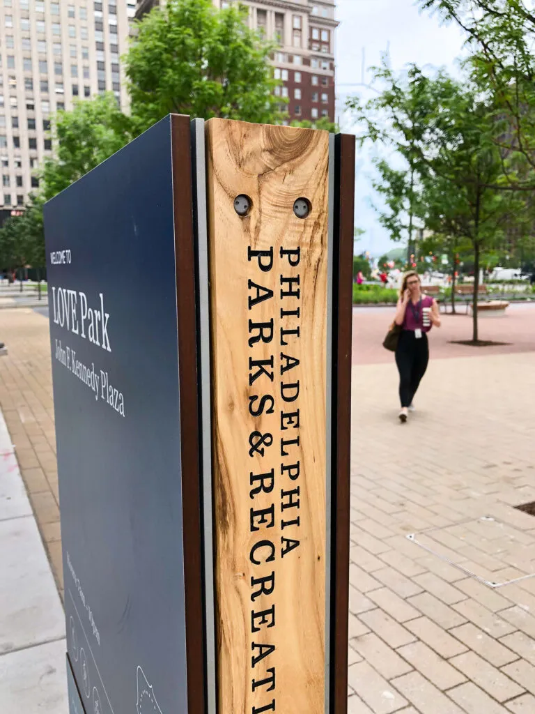 Wooden detail on side of sign, labeled with brand name