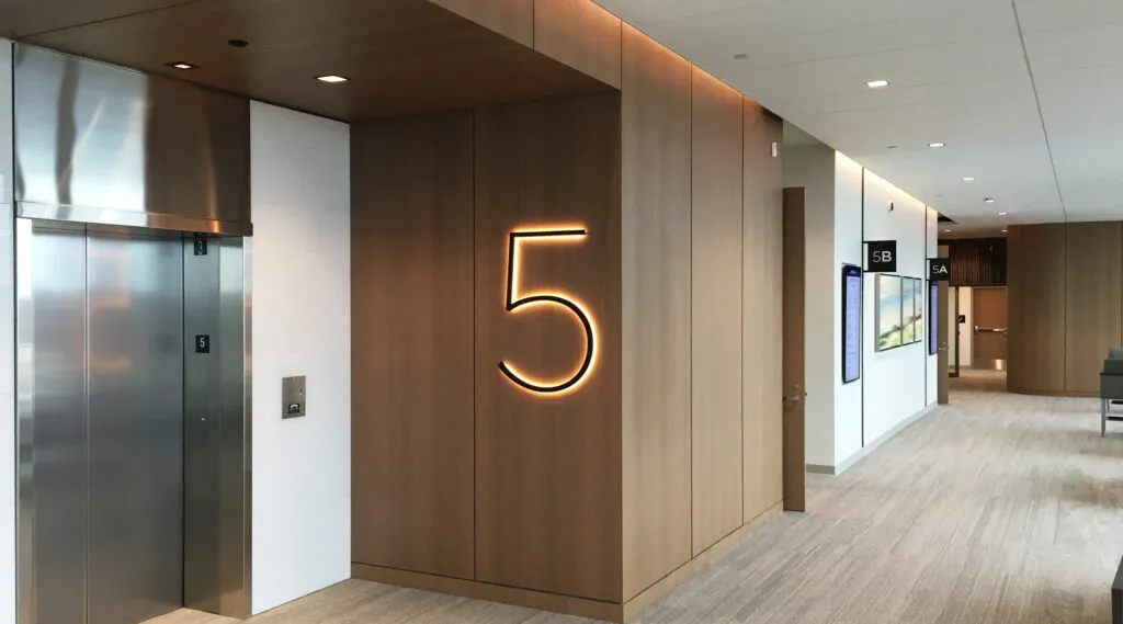 SSMHealth Fish Hatchery Level 5 dimensional five with halo lighting at Elevator with room identification flags in background