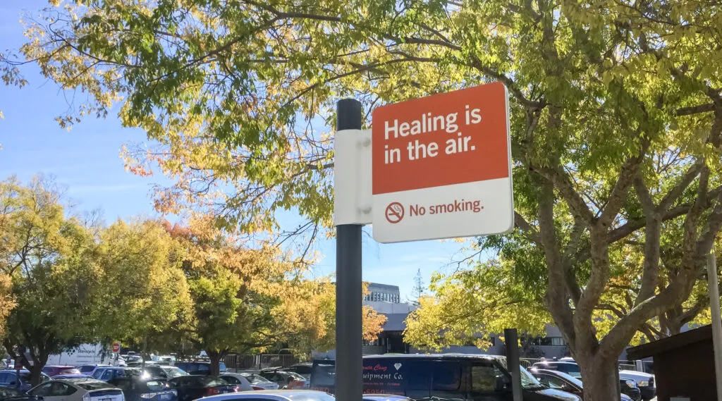Sing outside Dignity Health parking lot, sign reads: 