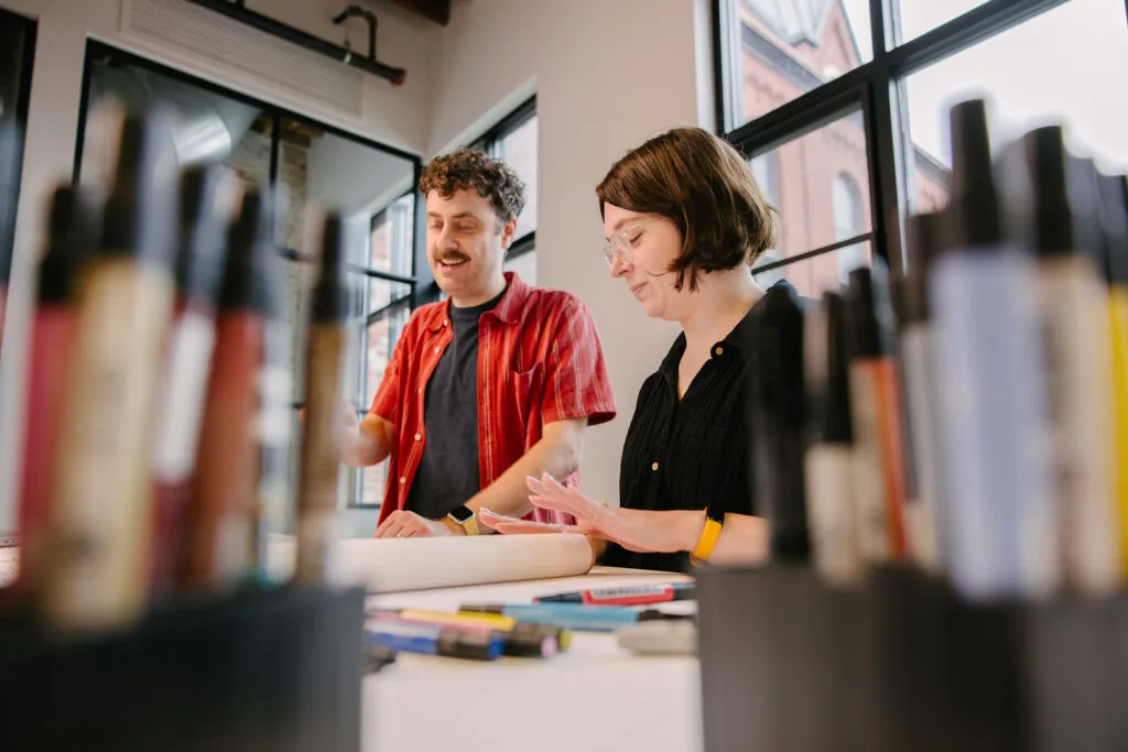 Exit staff marking up floor plans